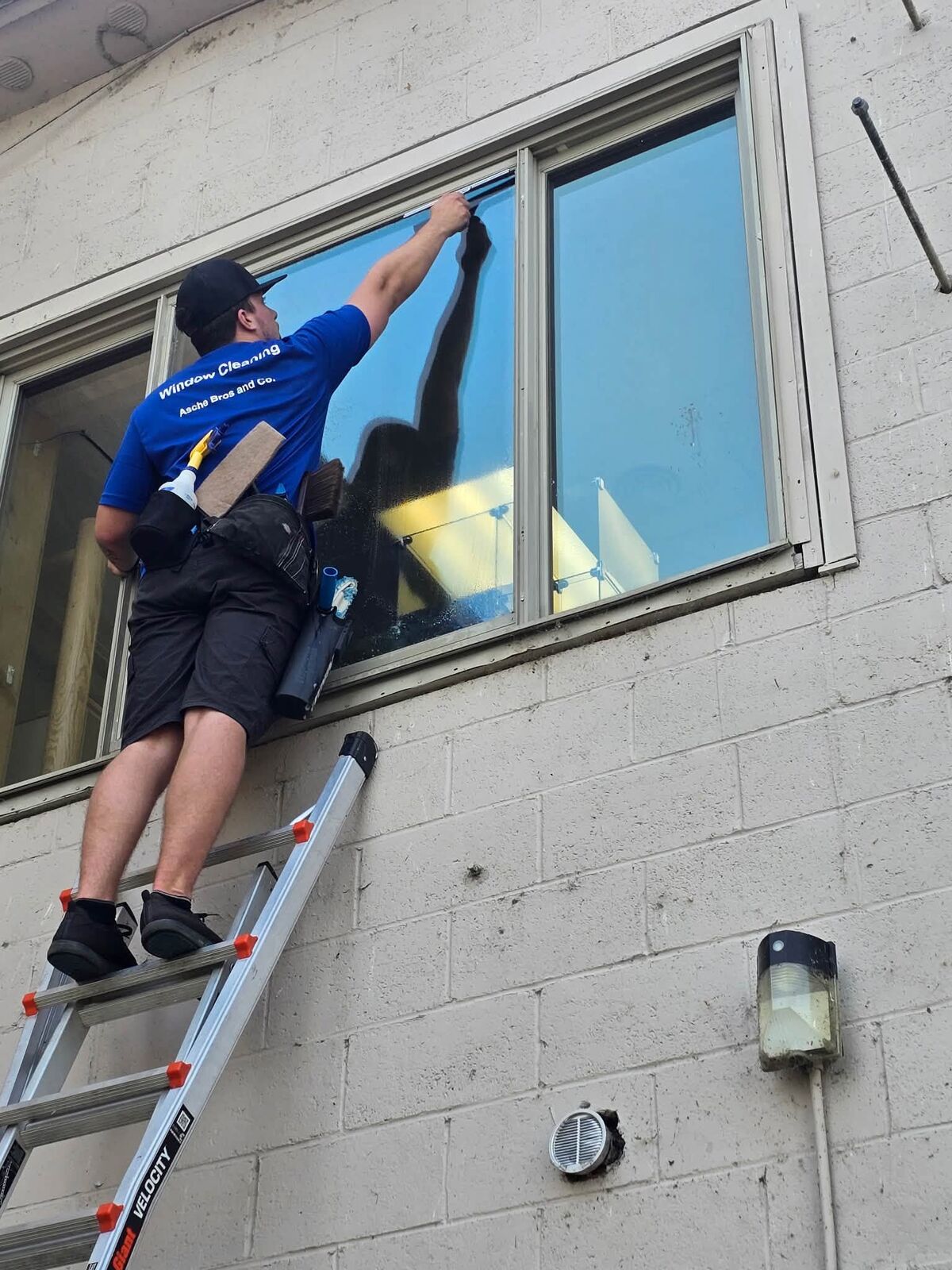 Squeegee detail work on commercial window